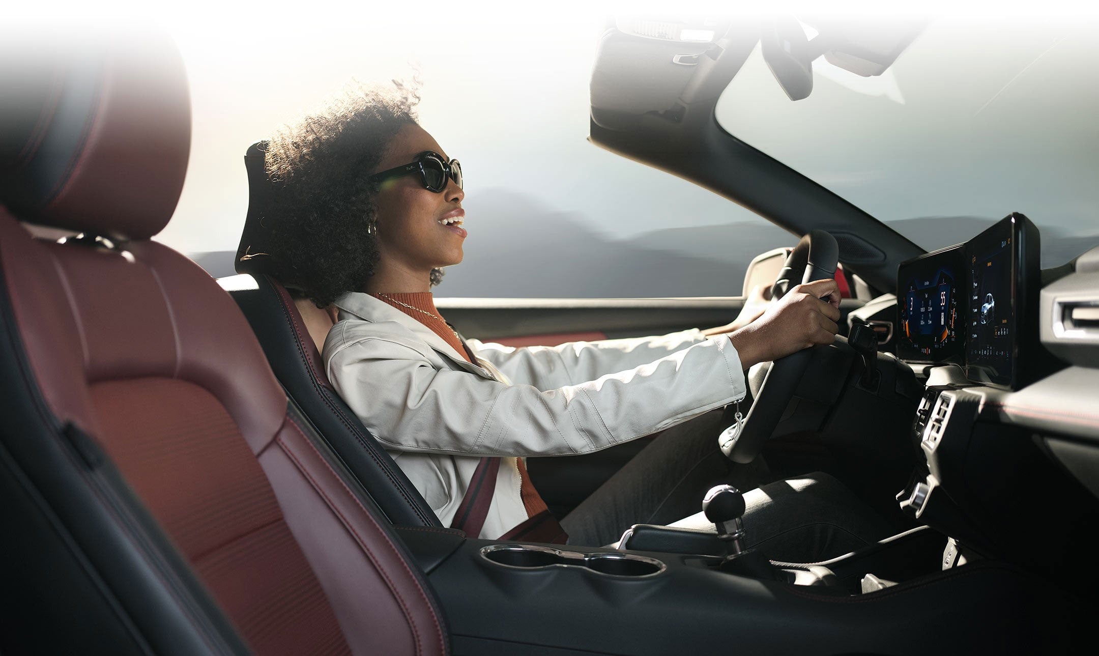 Person sitting in the driver’s seat of a 2024 Ford Mustang® convertible | Imperial Country Ford, Inc. in Imperial NE